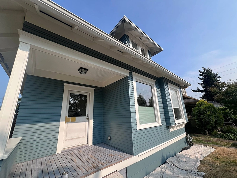 Two-tone body and trim repaint on an older Roosevelt neighborhood home in Bellingham after lead-safe prep