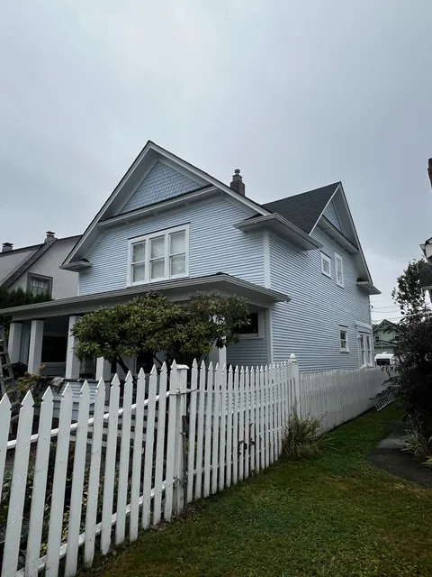 Side elevation of a Broadway Park home in Bellingham after exterior painting, showing repaired soffits and continuous siding.