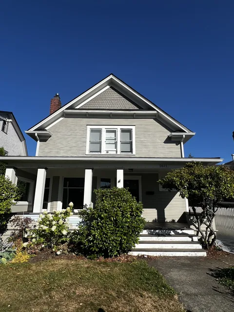 1909 Victorian in Bellingham's Broadway Park Historic District before exterior painting, with chalked and faded paint.