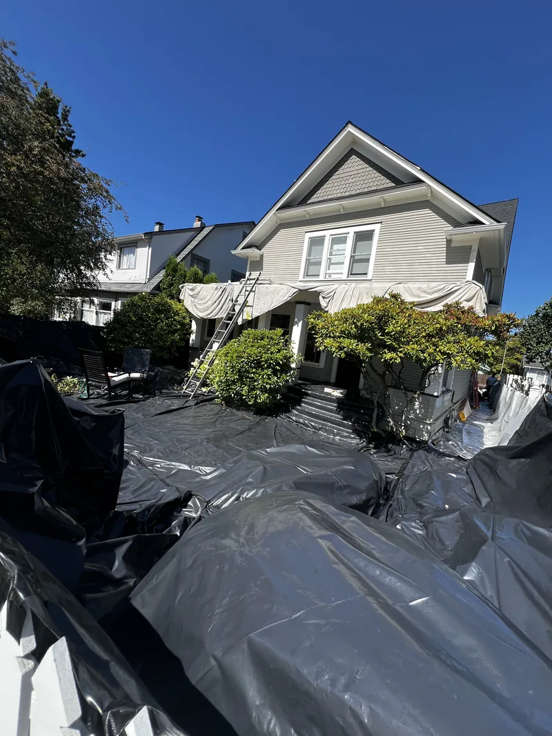 Yard, patio and porch of a Broadway Park home in Bellingham sealed under poly sheeting for lead-safe paint removal.