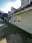 Finished side of the house with fresh siding and white window trim