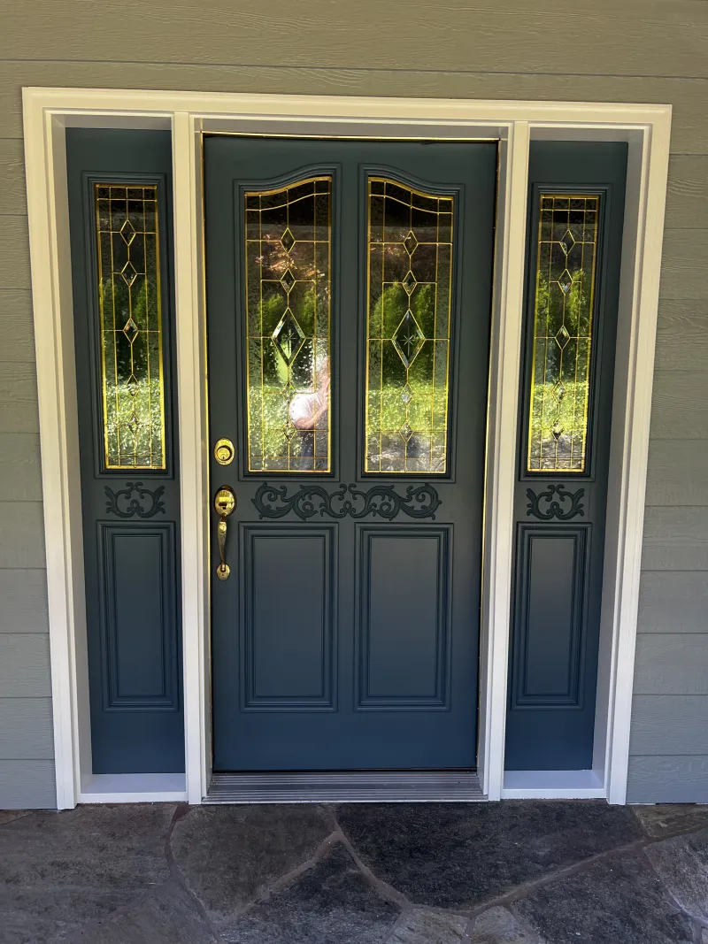 Finished Waterloo blue front door with leaded-glass sidelights and Pure White trim on a home on Chuckanut Drive