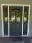 Finished blue front door with leaded-glass sidelights and white trim on a home on Chuckanut Drive