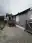 Rear of the Eldridge bungalow after repainting—gray siding, white trim, and a red-painted back porch and steps, Bellingham, WA.