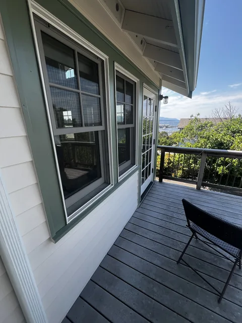 Finished window trim and siding on the covered deck of a Fairhaven home, looking out over Bellingham Bay.
