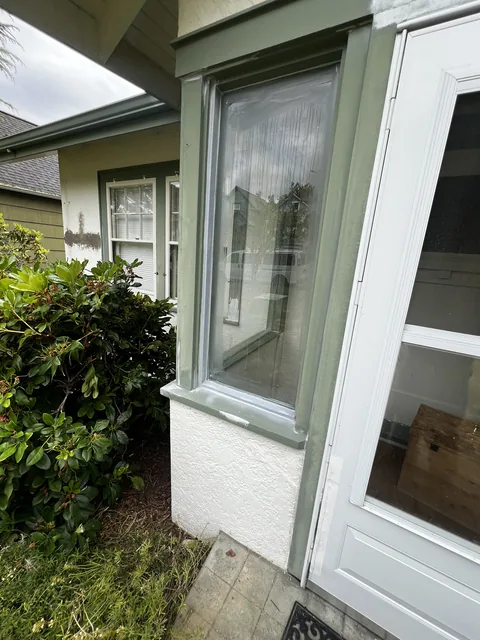 Rebuilt and repainted window casing on a Fairhaven home in Bellingham, WA—damaged trim repaired before finish coats.