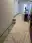 Office hallway with drop cloths and masked trim protecting floors and furniture during commercial painting