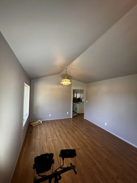 Color-drenched living and dining room in Bellingham's King Mountain neighborhood filled with daylight, the deep color reading soft and almost greige.