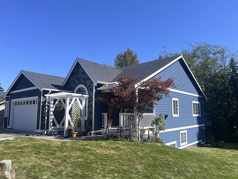 Two-story Bellingham home in the Whatcom Falls area repainted in Van Deusen Blue with soft-gloss white trim