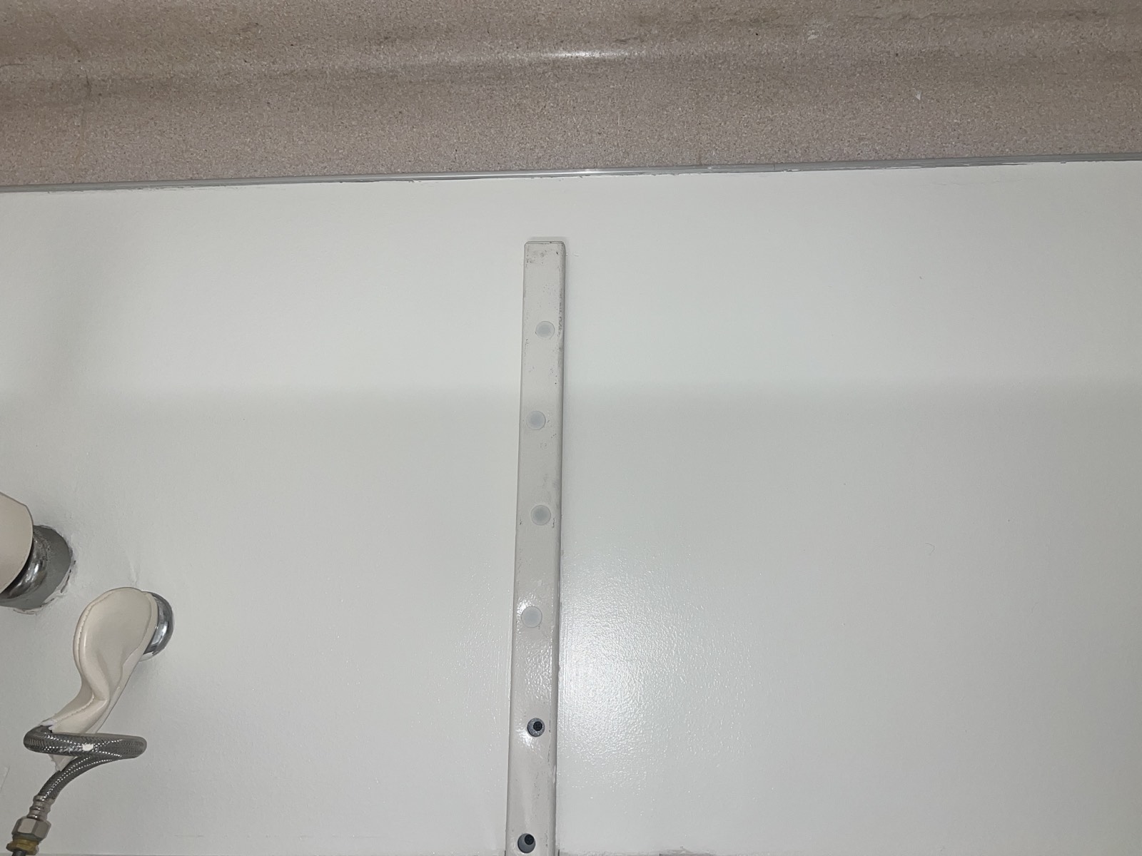 The finished wall perfectly painted with no visible signs of the previous damage
